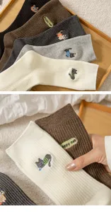 Detail view of women's autumn winter ribbed cotton mid-calf socks with cute cat embroidery.