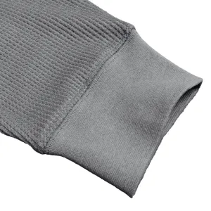 Detailed close-up view of the comfortable grey waffle knit long sleeve shirt cuff.