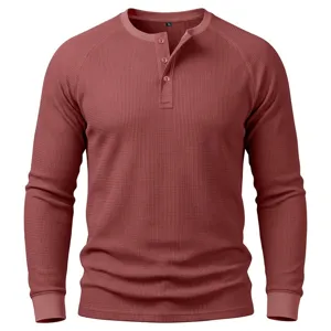 Close-up of men's waffle knit long sleeve Henley shirt with three button placket texture.