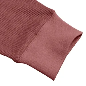 Close-up view of men's long sleeve waffle knit shirt sleeve cuff with ribbed texture.