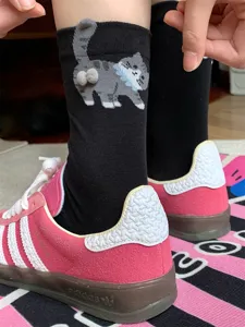 Cute 3D cat mid-tube socks for women, black cotton funny animal socks with fluffy pom-pom tails.