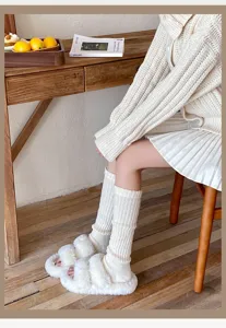 White knitted leg warmers and fuzzy slippers, cozy warm winter calf socks for women.