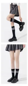Close-up detail of black JK calf socks featuring classic white stripes for student daily wear.