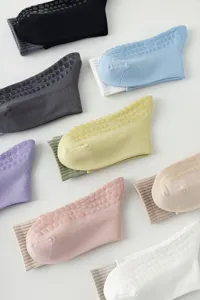 Detailed view of colorful non-slip yoga socks with silicone grip dots for fitness workout.