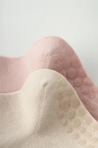 Detailed view of women non-slip yoga pilates grip socks with soft knit fabric and dots.