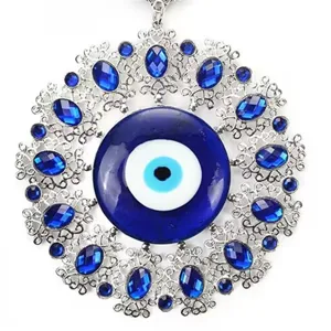 Detailed view of silver filigree Evil Eye ornament with blue crystals for platter decor