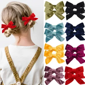 Vibrant set of velvet bow hair clips for girls, featuring multiple colors and model view