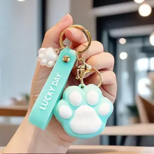 Detailed view of cute mint green cat paw keychain with Lucky Day embossed soft strap