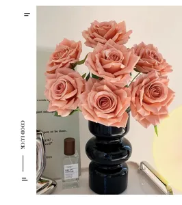 Elegant peach artificial rose bouquet in a modern black vase for home interior decor