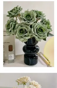 Detailed view of artificial green rose bouquet set in a sleek black ceramic vase