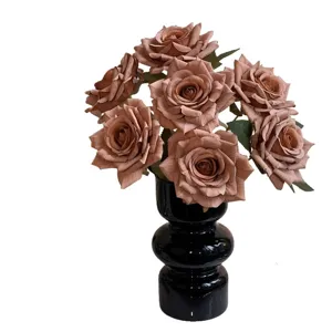 Realistic artificial rose bouquet in an elegant black ceramic vase for home decor