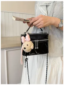 Black quilted chain vanity bag for women, elegant crossbody shoulder bag with cute bear charm.