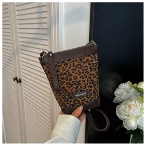 Leopard print crossbody phone bag, fashion small shoulder bag with brown leather trim and zipper.