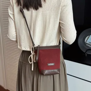 Casual small suede crossbody shoulder bag for women, stylish minimalist bucket bag design.