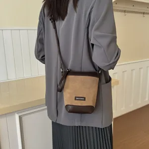 Stylish mini crossbody phone bag detail showing premium leather patchwork design.