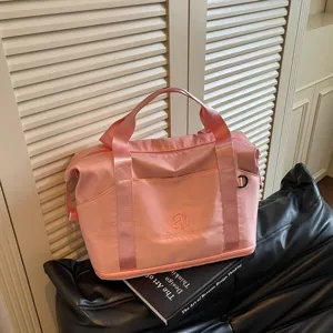Pink travel duffel bag for women, portable shoulder fitness gym bag for short trips.
