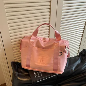 Pink travel duffel bag for women, portable handbag and shoulder fitness bag for sports and gym.