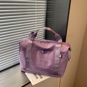 Purple travel duffel bag detail, portable gym tote, casual sports handbag with zipper.