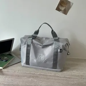 Grey travel duffel bag for women, portable tote shoulder bag for gym, fitness, and short trips.