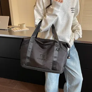 Stylish black travel duffel bag for women, portable shoulder handbag for daily sports and gym.