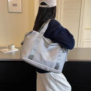 Detail view of the lightweight grey travel gym bag with sturdy straps and functional design.