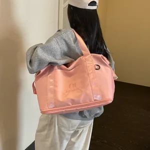 Detail view of pink travel duffel bag showcasing large capacity and stylish casual design.