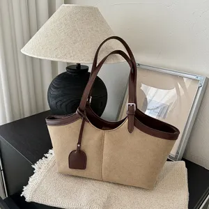 Vintage canvas tote bag for women, two-tone shoulder handbag with large capacity and stylish design.