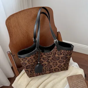 Vintage leopard print tote bag for women, stylish shoulder handbag with black leather straps.
