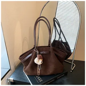 Brown suede tote bag for women, stylish commuting shoulder handbag with cute bear pendant.