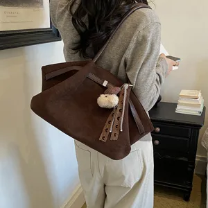 Brown suede shoulder tote bag with cute dog pendant, stylish retro commuting handbag for women.