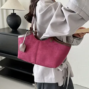 Stylish vintage burgundy faux suede tote bag detail showing texture and brown leather trim.