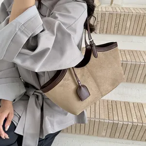 Detailed view of women's vintage suede tote bag, stylish underarm shoulder bag design.