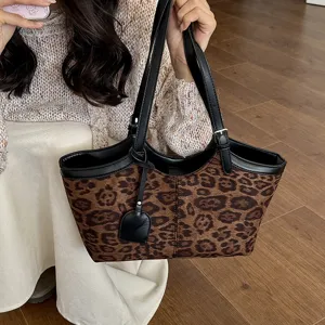 Stylish leopard print tote bag for women, retro shoulder bag with black leather trim and handles.
