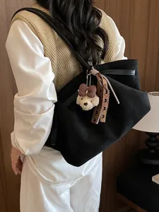 Women's black shoulder tote bag with cute plush puppy pendant and stylish pleated design daily.