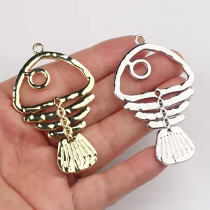 Detailed view of minimalist alloy hollow fish bone pendants for DIY necklace and bracelet making.