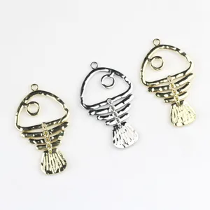 Close-up of hollow fish skeleton alloy pendant charms, perfect for DIY jewelry making.