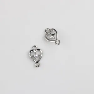 Close up detail view of silver alloy heart double loop connector charms for DIY crafts.