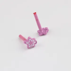 Close-up detail of pink painted star ear post jewelry accessory, showing smooth matte finish.