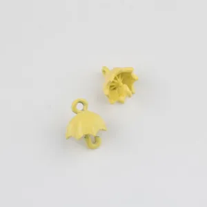 Close-up detail shot of cute yellow umbrella alloy charms, perfect for DIY jewelry making.