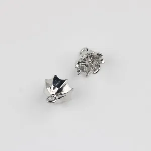 Detailed shot of miniature silver metal umbrella charms, DIY jewelry accessories detail view.