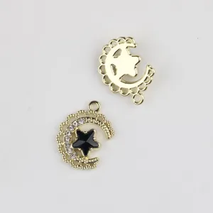 Gold alloy crystal black star crescent moon pendant DIY jewelry accessory close up.