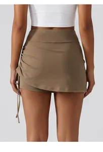Detail view of womens high waist yoga skort with side ruching and built-in athletic shorts.