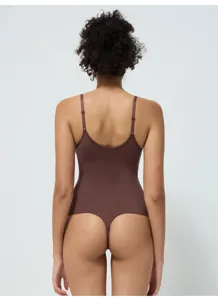 Brown thong bodysuit for women, seamless shaping shapewear with thin straps and elastic fabric.