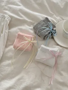 Detailed shot of cute Japanese style ruffle mid-calf socks with sweet ribbon bows in multi colors.