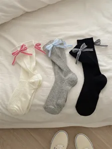 Detail view of Japanese style plaid bow ribbed crew socks in white grey and black colors.