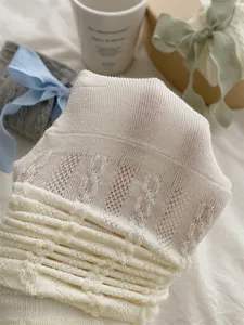 White knitted stack socks for women, cute hosiery with delicate hollow out lace design.