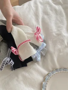 Detail shot of Japanese style plaid bow mid-tube socks, soft fabric texture and cute design.