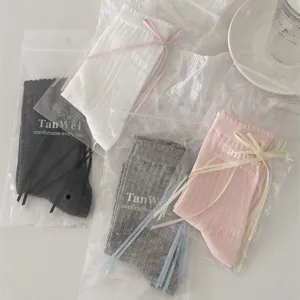 Sweet JK style mid-calf slouch socks with cute ribbon bows and delicate lace ruffles.