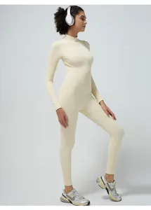 Detailed view of the beige ribbed long sleeve activewear jumpsuit for fitness and pilates training.