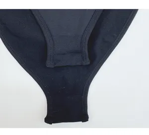 Close-up detail of seamless black athletic bodysuit fabric showing fine stitching and elasticity.